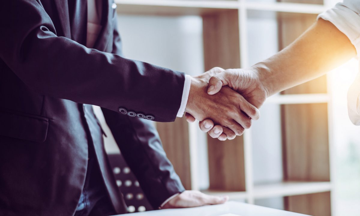 Middle age partner lawyers attorneys shaking hands after discussing a contract agreement done, Asian people.